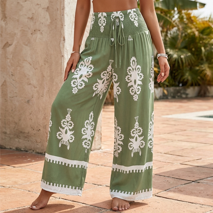 Bohemian-Inspired Flowing Wide-Leg Pants with Ornate Gathered Waist and Decorative Hem