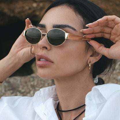 Retro-Inspired Oval Sunglasses with Sleek Metallic Frames and Patterned Temples